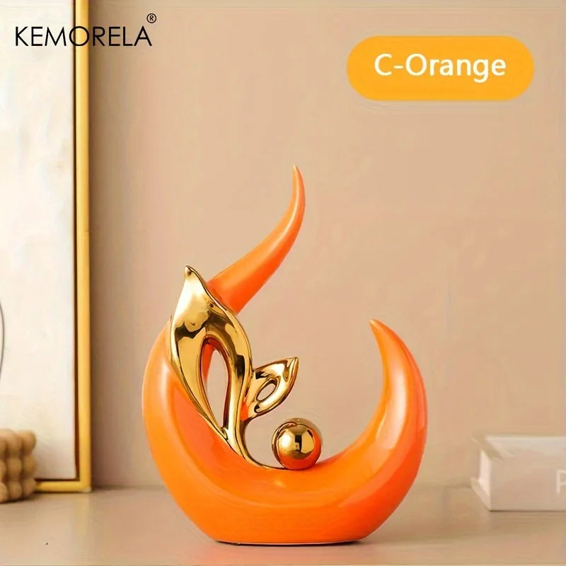 Orange ceramic Nordic figurine with gold bird detail on teardrop base, angled view