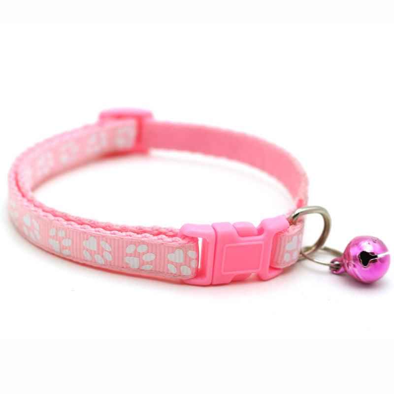 Pink pet bell collar set with paw-print pattern, adjustable buckle, and dangling bell