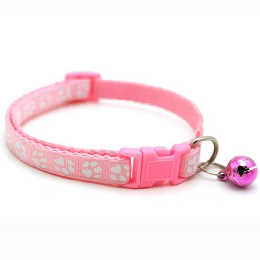 Pink pet bell collar set with paw-print pattern, adjustable buckle, and dangling bell