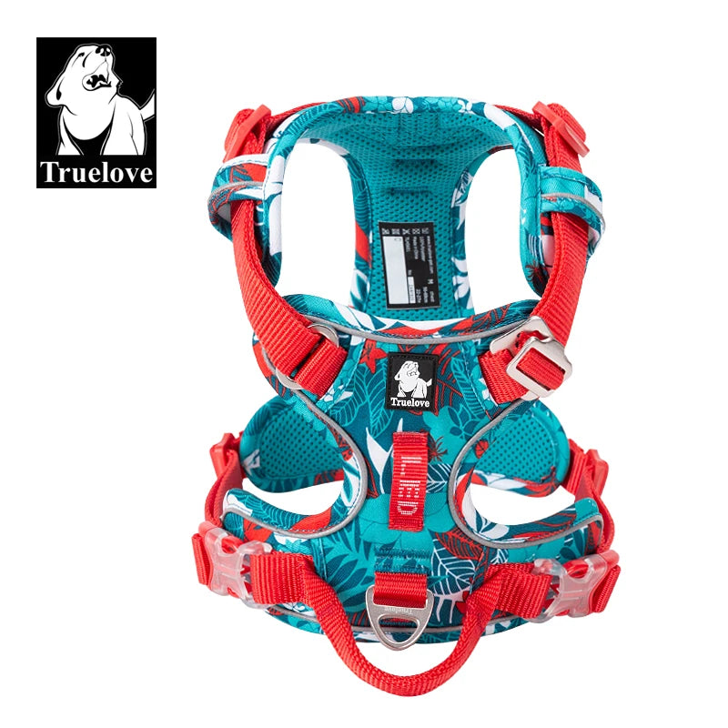 Dog harness with turquoise camouflage fabric, red straps, metal rings, and Truelove label