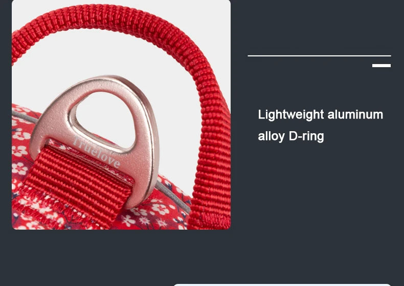 Red floral no-pull harness close-up of aluminum D-ring with braided strap