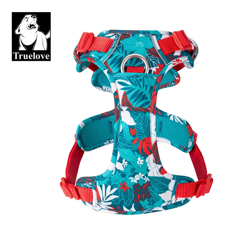 Dog harness with teal floral/camouflage pattern, red straps, and reflective trim