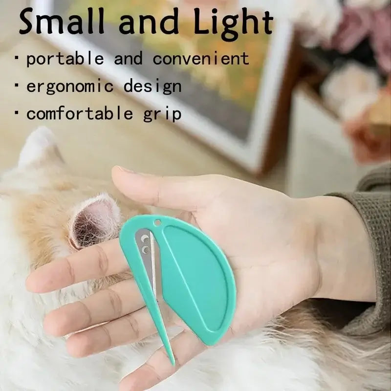 Green grooming knotting comb small design, held in palm by dog paw fur