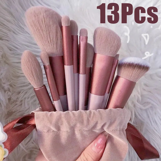 13-piece makeup brush set with beige fabric pouch; rose-gold handles and soft bristles.