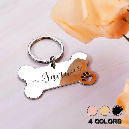 Personalized dog ID tag keychain with Luna name and paw-print bone cutout.