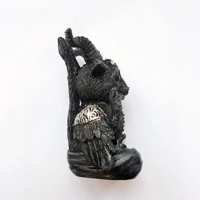 Dark resin goat desktop ornament back view with hanging pendant and folded cape