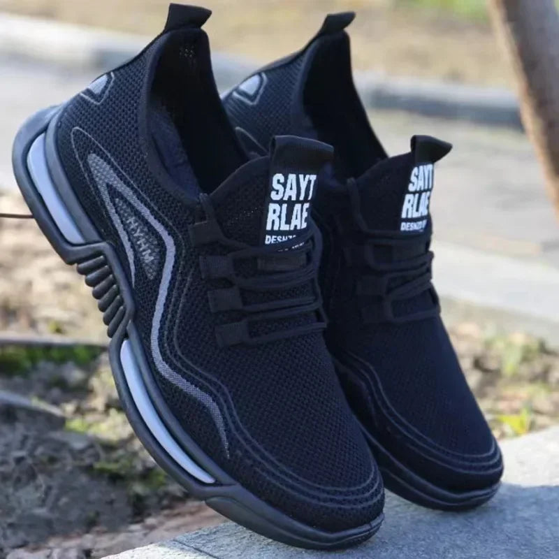 Black slip-on knit sneakers with thick cushioned sole, side stripe, and logo patch