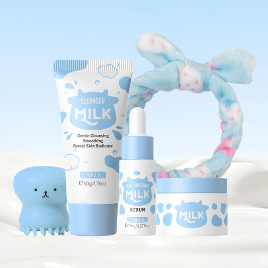 Milk skincare travel set with cleanser tube, serum bottle, and cream jar