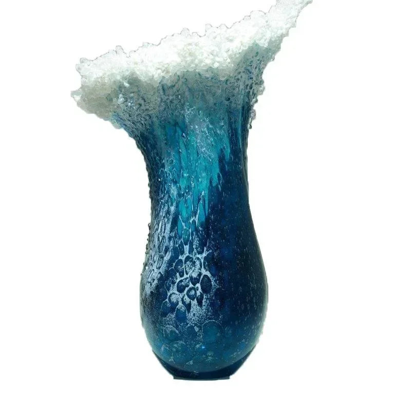Blue resin vase with white wave top and bubble-like texture details on the body.