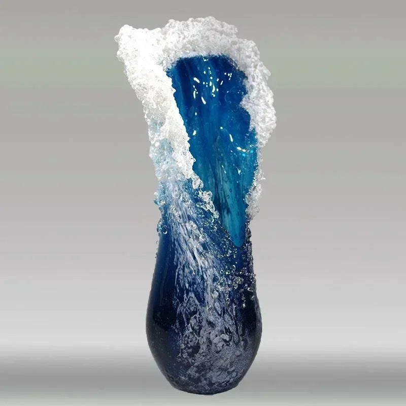 Blue resin vase with white wave-like top and textured ripples along the body.