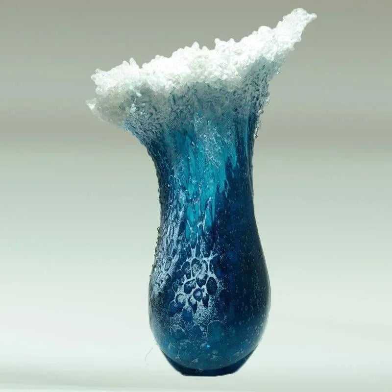 Teal-blue resin vase with white-capped top and mottled textured finish.