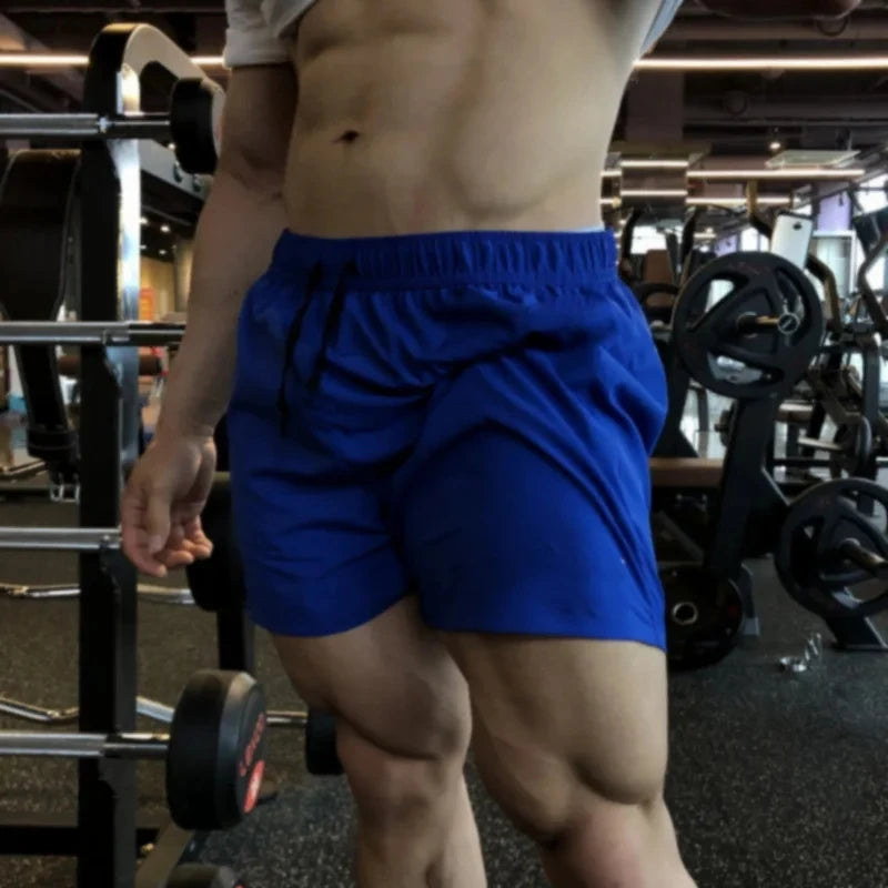 Men's blue athletic shorts with elastic waist and drawstring ties