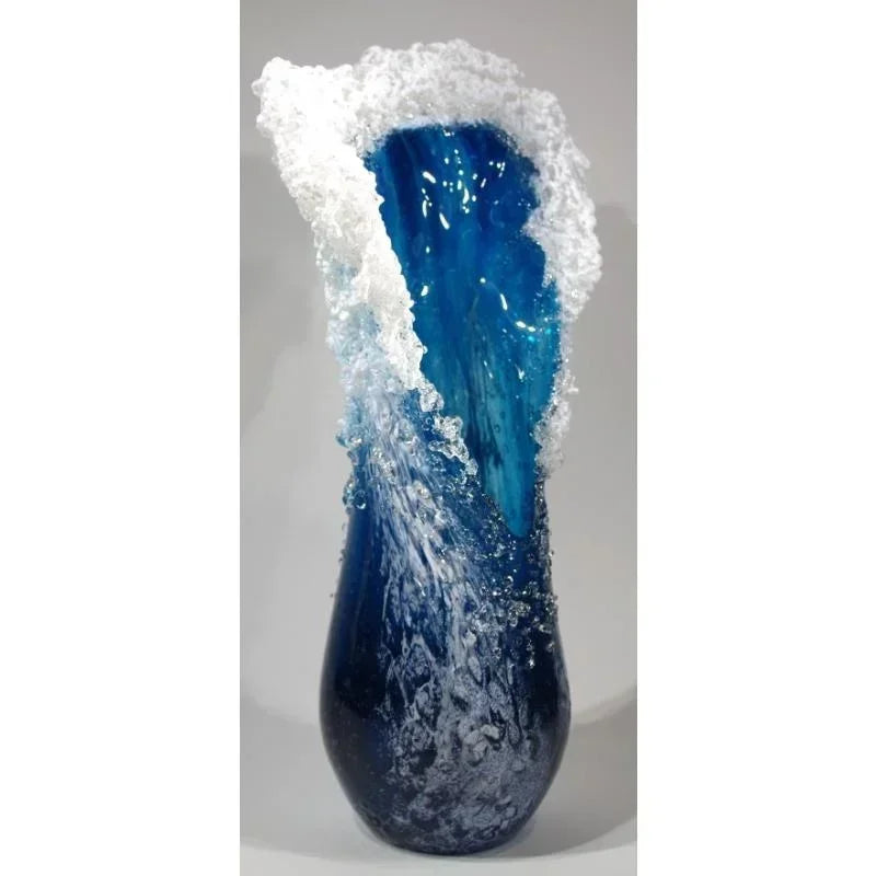 Navy-blue resin vase with white frothy rim and dark textured base.