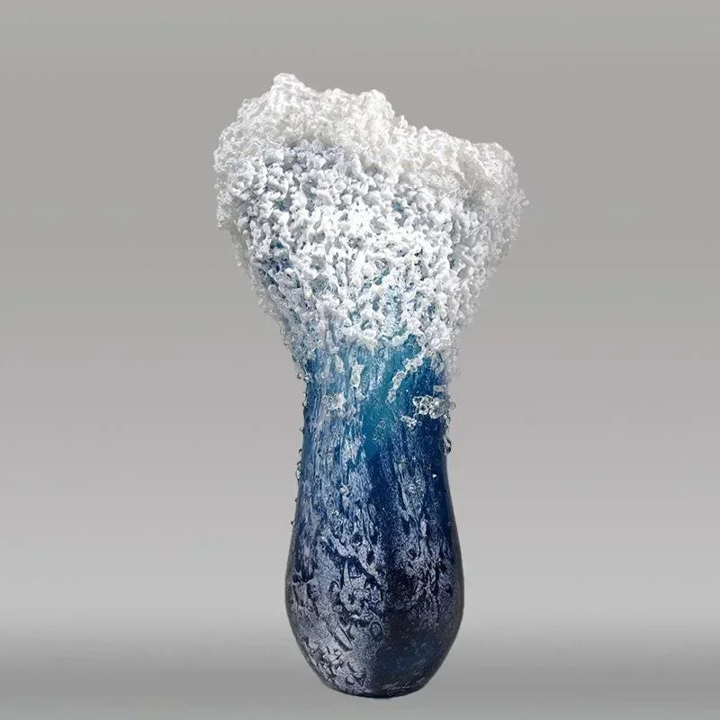 Blue resin vase with foamy white rim and swirling wave texture across the surface.
