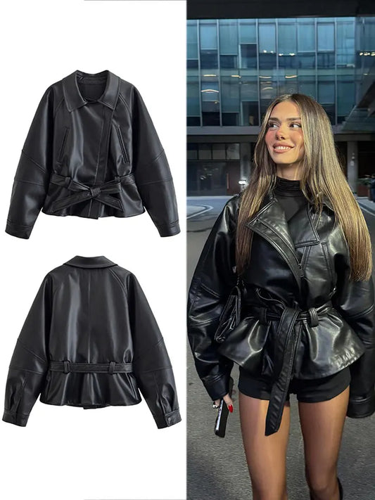 Black faux leather belted moto jacket with stand collar and long sleeves.