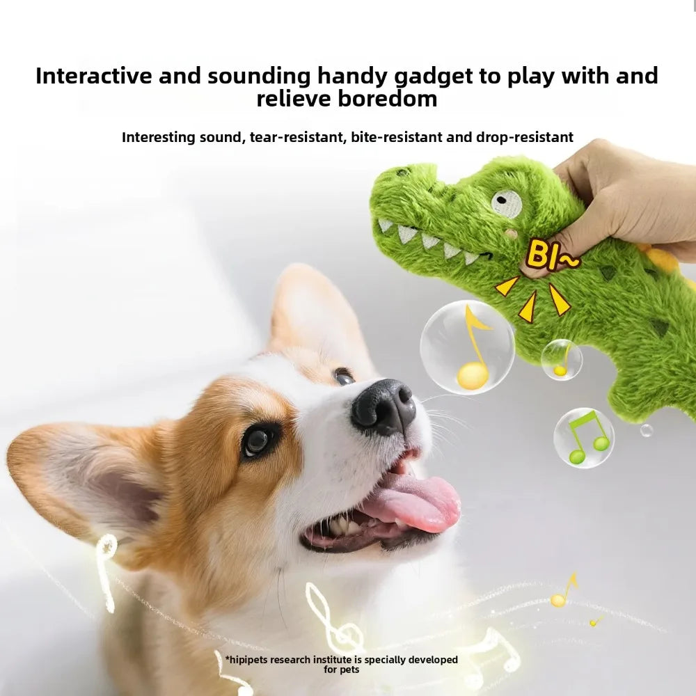 Green plush crocodile squeaky dog toy held by hand, soft fabric body