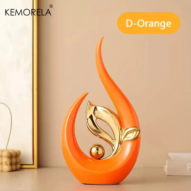 Orange ceramic Nordic figurine with gold bird on teardrop base and round accent