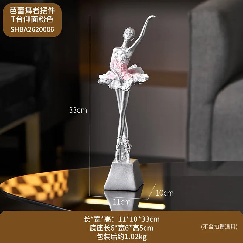 White ballet dancer resin sculpture with silver finish, pink tutu accents, on base