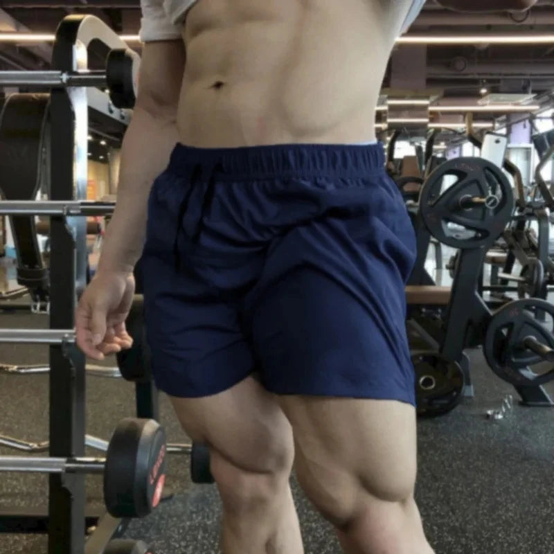 Men's navy blue athletic shorts with elastic waist and drawstring ties