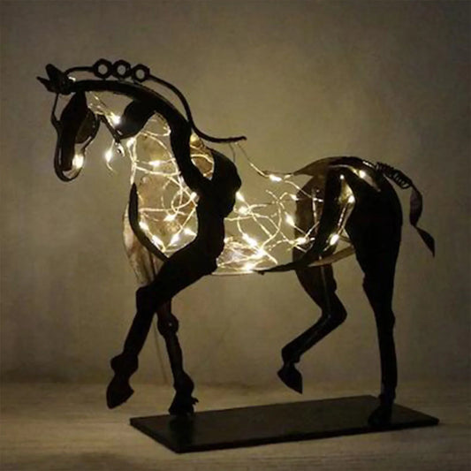 Abstract metal horse sculpture with warm string lights on a flat base
