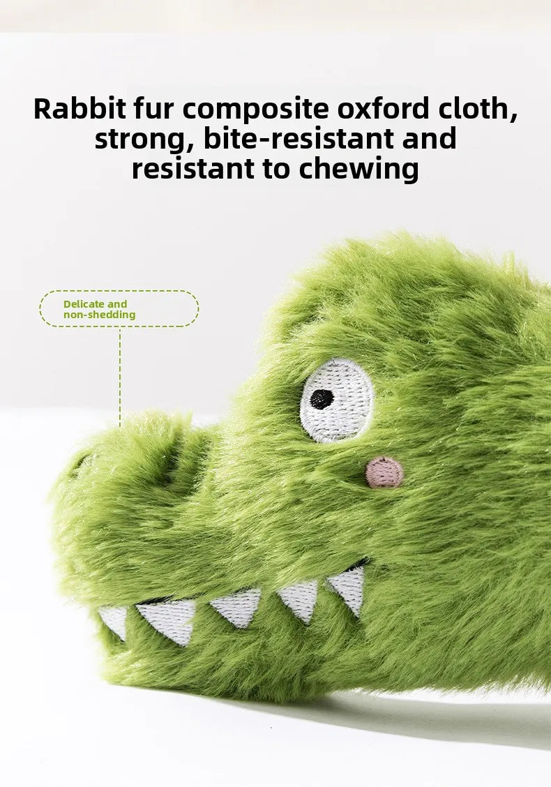 Green plush crocodile dog toy close-up with embroidered eye and toothy grin